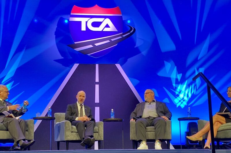People seated on stage at TCA convention