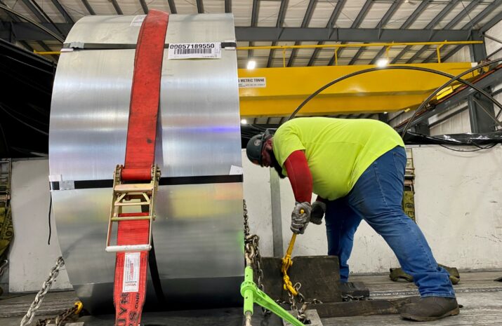 Man chaining down a load on a flatbed