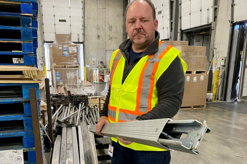 Picture of Michael Frolick carrying a load bar.