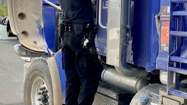 Police officer on the step of a truck