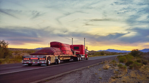 Long Haul Semi Truck On a Rural Western USA Interstate Highway alternate text for this image