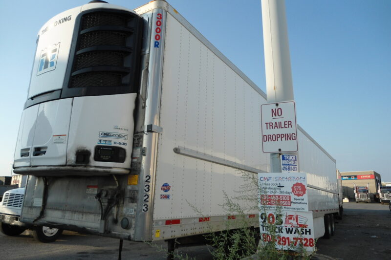 Picture of a trailer next to a sign