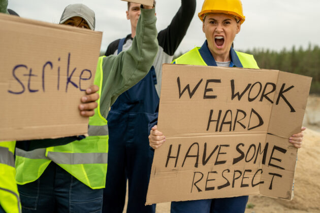 Crowd of dissatisfied builders on strike alternate text for this image