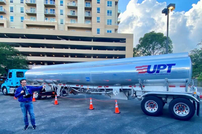 Man with bullhorn standing in front of a tanker