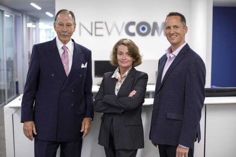 The image is of Jim Glionna(Left) with his son, Joe (Right) and his assistant Janice Zealand (center)