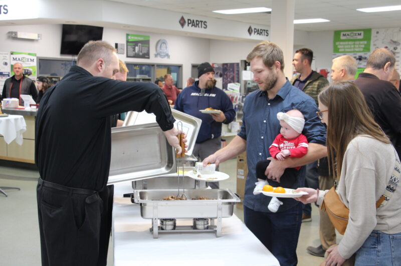A man serves people breakfast