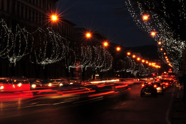 Lightstrails of vehicles in movement on the road in Florence city during Christmas season. Italy alternate text for this image