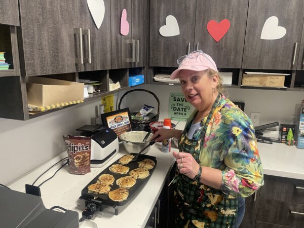 Sue-making-pancakes-for-MBT-staff-2024 alternate text for this image