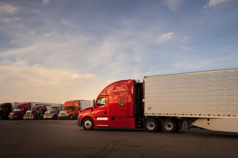 BIg red semi trailer entering a truk stop resting area in Utah, USA