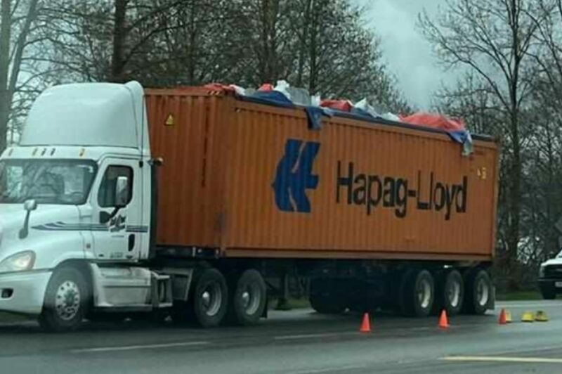 Truck hauling a damaged container