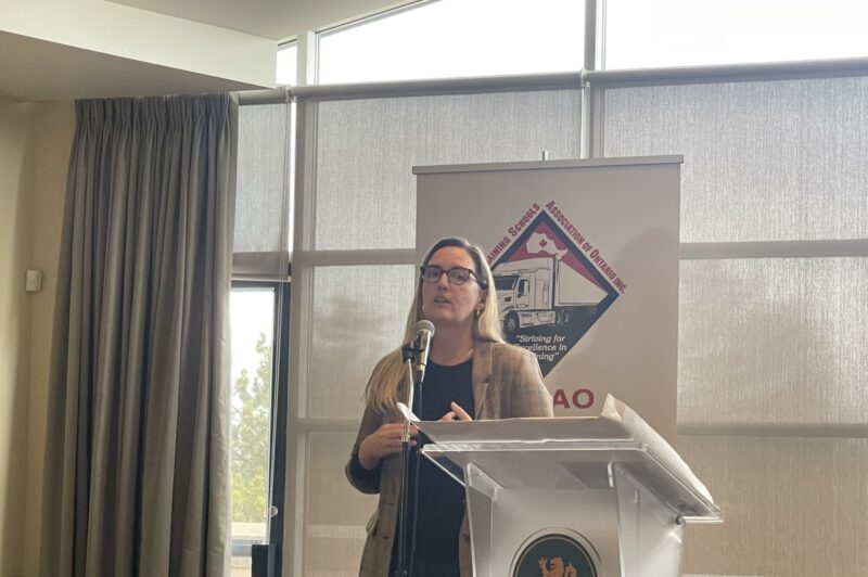 Jaqueline Caceres, president of BIS Risk Solutions, is on the podium presenting the captive markets for trucking companies during the TTSAO's conference