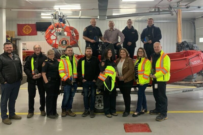 People standing in front of a boat