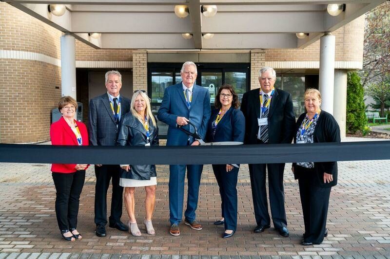 Verspeeten family cutting the ribbon at the opening of its family cancer center
