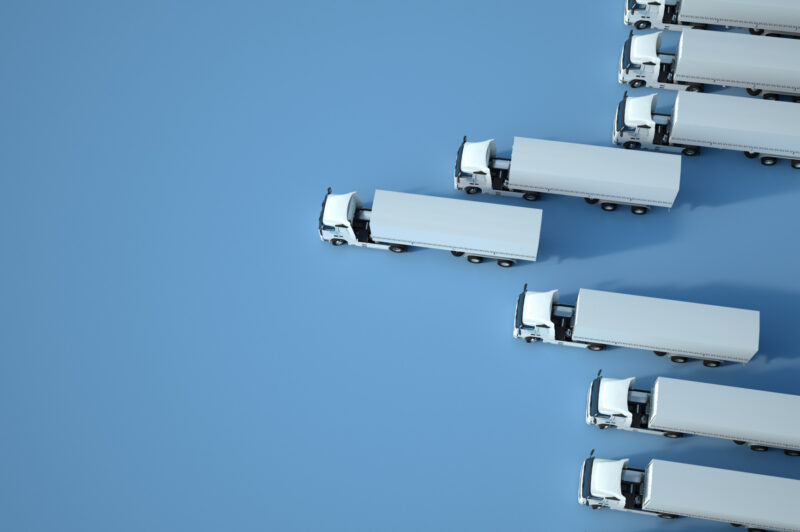 3D rendering of white trucks against a blue background, aerial view