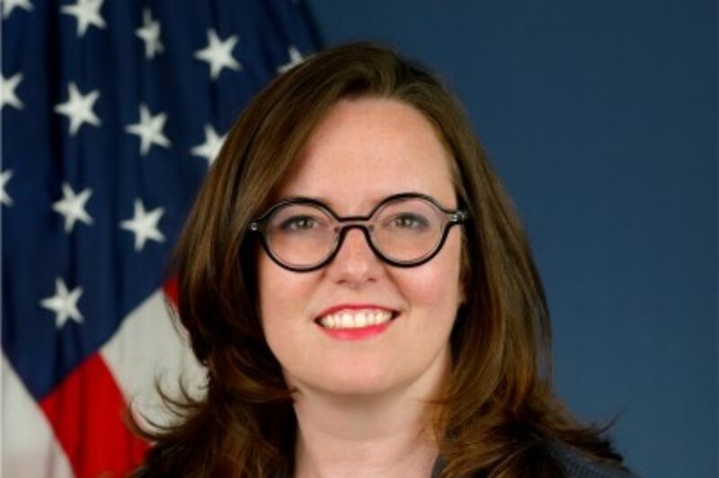 Headshot of Melody Drummond Hansen with US flag