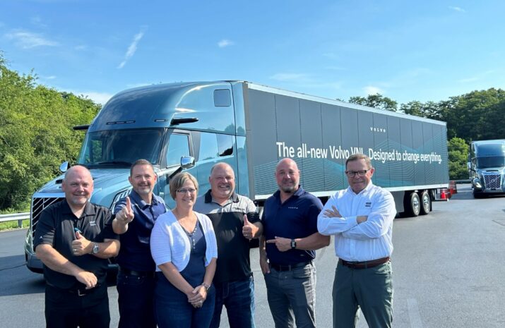 A group photo of 6 people in front of the new VNL truck