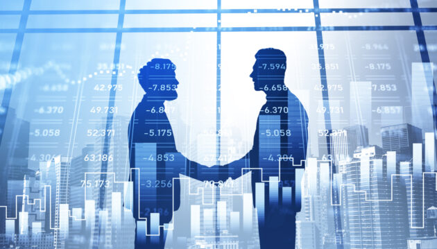 Silhouettes of businessmen having a handshake. Panoramic city view in the background. Financial charts in the foreground. Concept of networking and cooperation on stock market alternate text for this image
