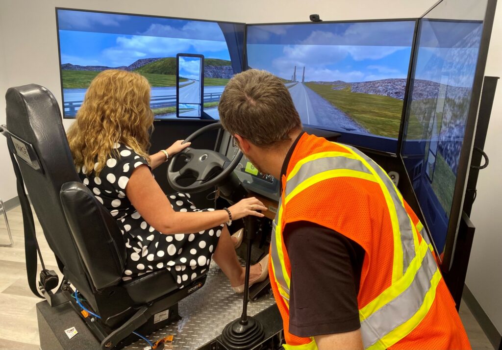 A woman tries out a truck simulator