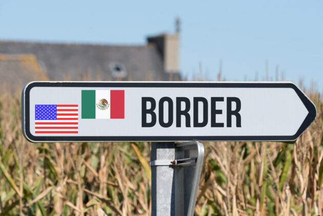 A sign indicates the U.S.-Mexico border alternate text for this image