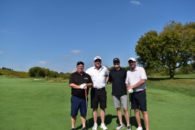 four people at the gold course during Erb golf tournament 2024