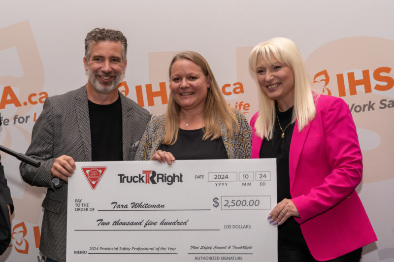 Tara Whiteman, middle, with Rick Brown and Eugenia Churilov presenting her with the check