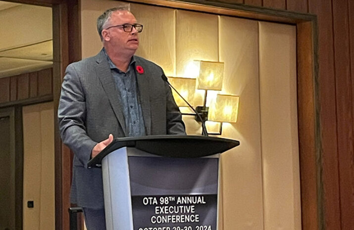 Bylsma at the podium speaking