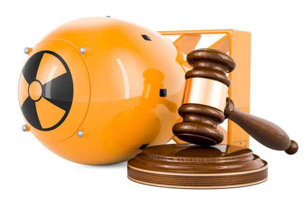 Atomic bomb with wooden gavel, 3D rendering isolated on white background
