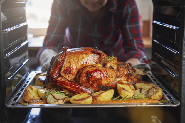 Roasting Turkey in the Oven for Holiday Dinner alternate text for this image