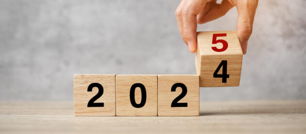hand flipping block 2024 to 2025  text on table. Resolution, strategy, plan, goal, motivation, reboot, business and New Year holiday concepts alternate text for this image
