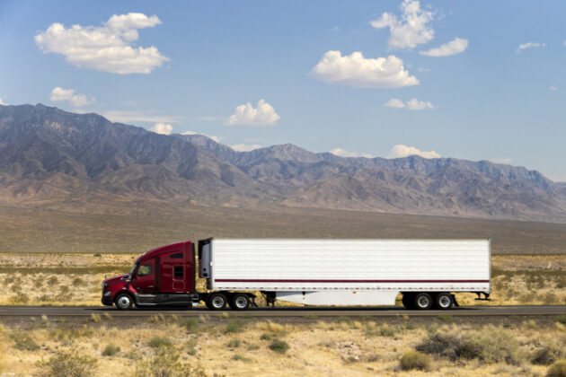 Fast and Powerful Heavy-Lift Modern Semi Truck Speeding on Highway, California, USA alternate text for this image