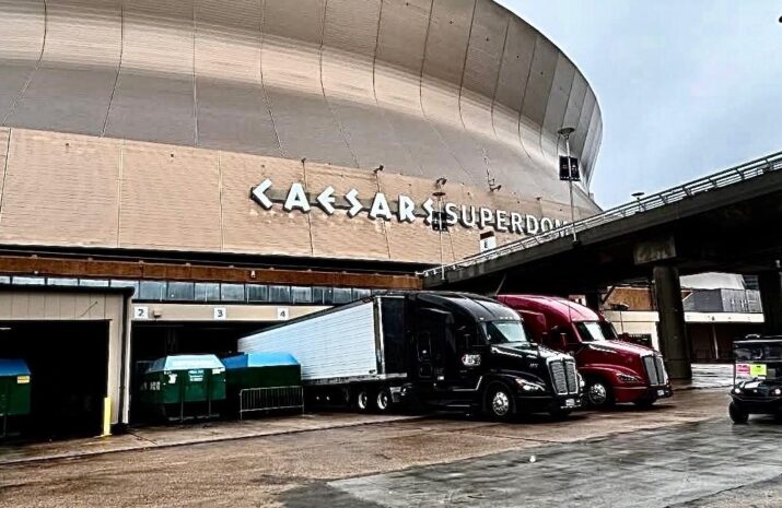 Picture of trucks delivering freight at a stadium