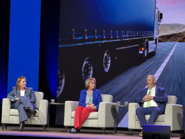 Edmondson, Koch and Morin, left to right, sitting on stage