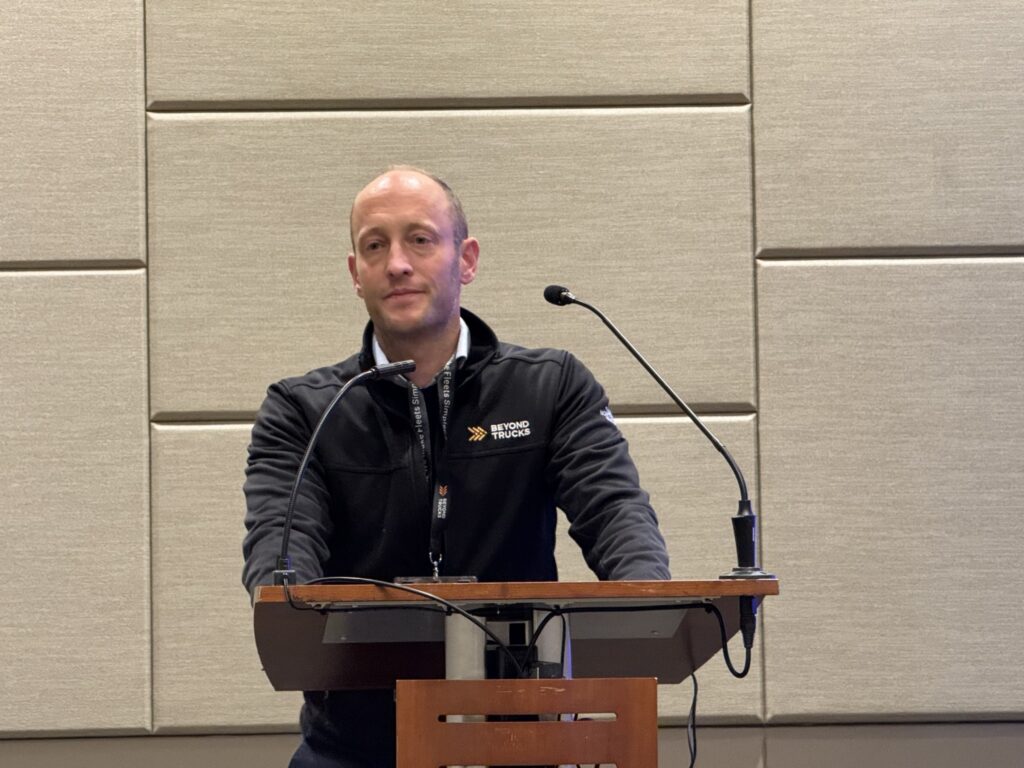 Hans Galland, CEO of BeyondTrucks, on tage talking to reporters