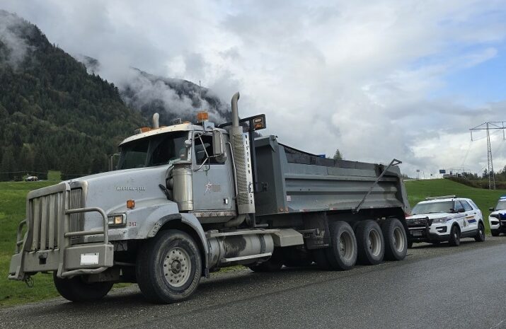 Picture of dump truck and two police patrol vehicles