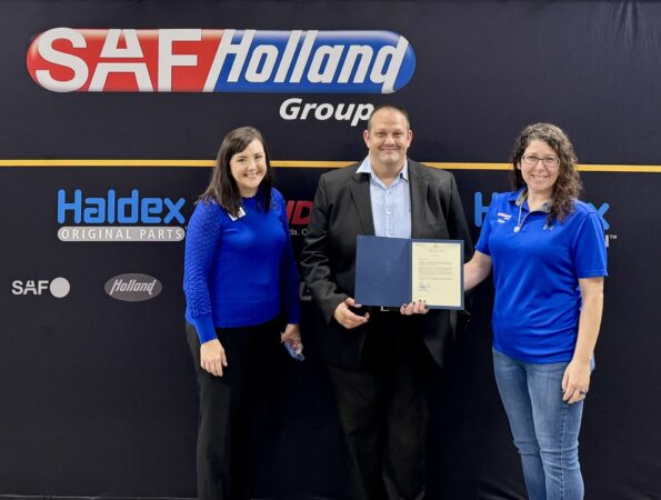 Nathan Duncan and Jamie Wilkins receiving a letter from Congressman Chuck Edwards