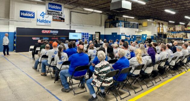 group of people sitting in chairs during a presentation