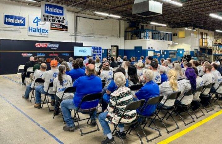 group of people sitting in chairs during a presentation
