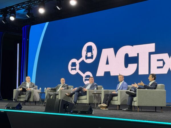 Photo of five people sitting on stage during the panel