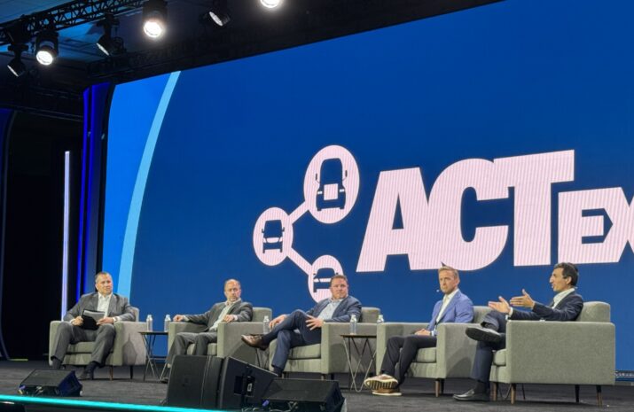 Photo of five people sitting on stage during the panel