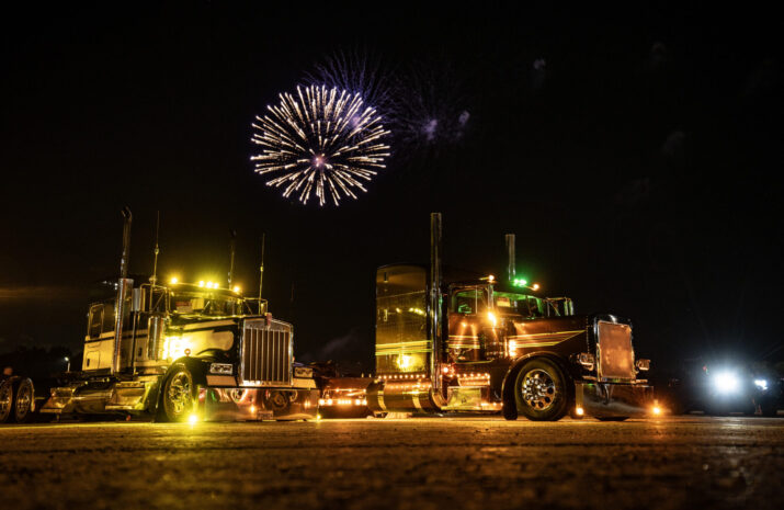 Fireworks over lit up trucks
