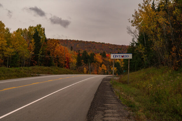 Ontario Tourism Sign against a Fall Background in Northern Ontario on a Highway alternate text for this image