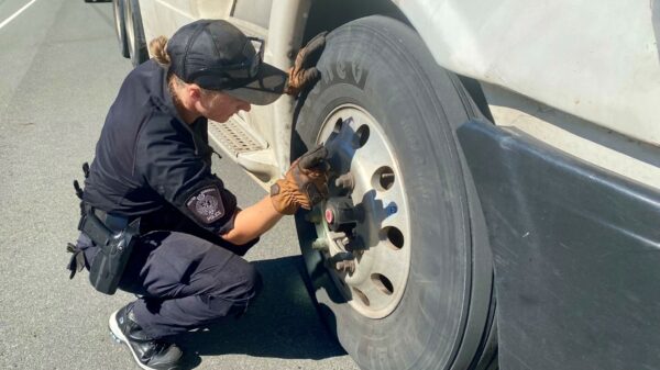 A police officer inspects a truck