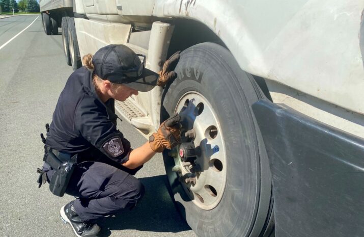 A police officer inspects a truck