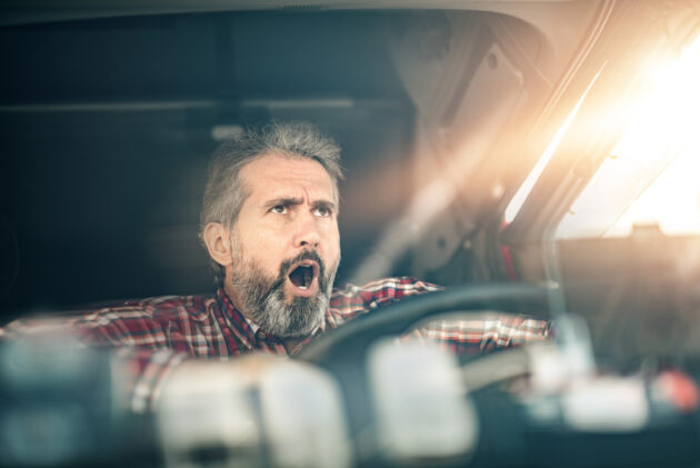 Mature truck driver encountering a traffic accident. alternate text for this image