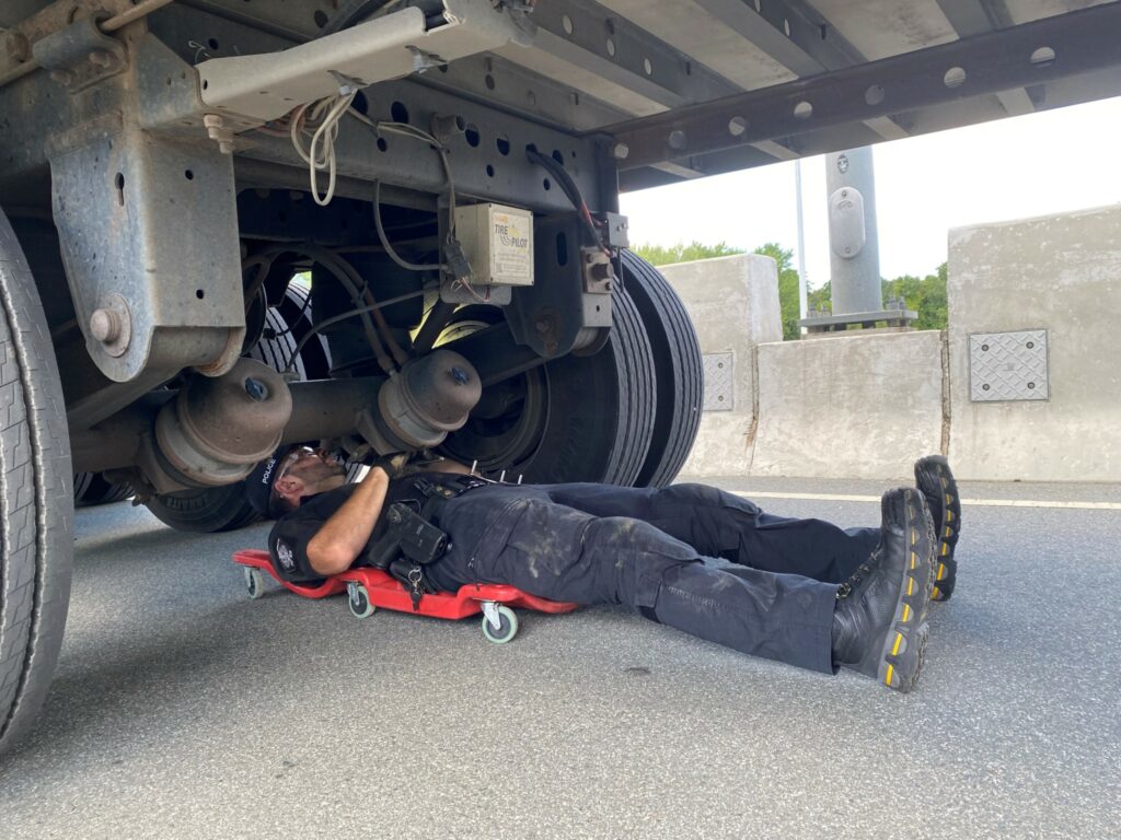 An officer inspects a truck