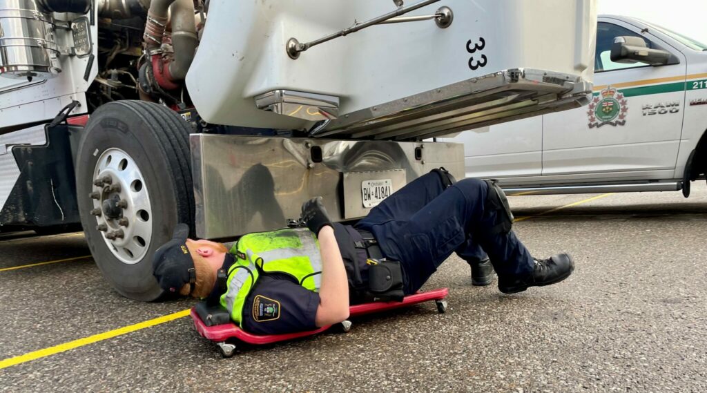 An officer inspecting a truck
