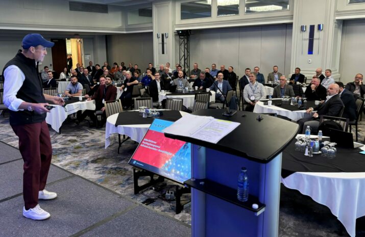 Picture of a man on stage addressing seated people