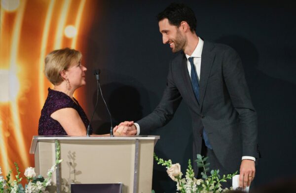 Picture of people shaking hands on a stage