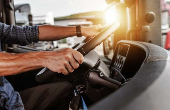 Truck driver holding steering wheel