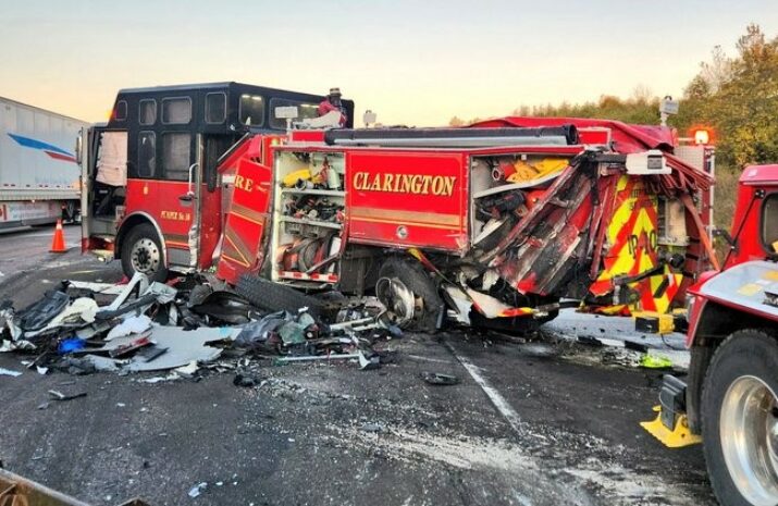 Picture of a damaged firetruck after it was hit by a tractor trailer